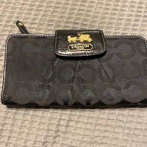 Coach Black signature canvas wallet with Gold carriage emblem.